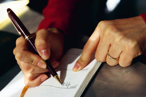 Woman Writing in Daily Planner